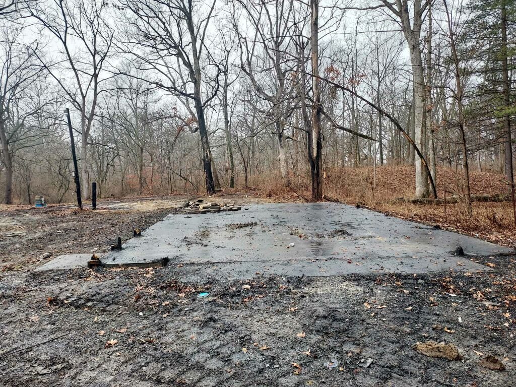 Cleared concrete slab after structure fire demolition cleanup in Northern Indiana