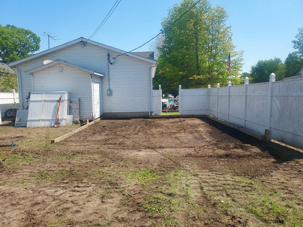 Bare dirt pad graded before gravel installation in Knox Indiana