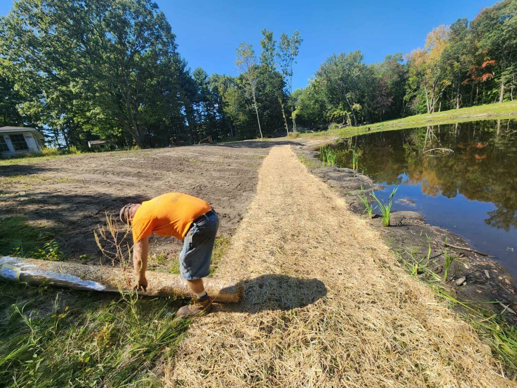 Erosion control blanket installation along pond bank in Knox Indiana