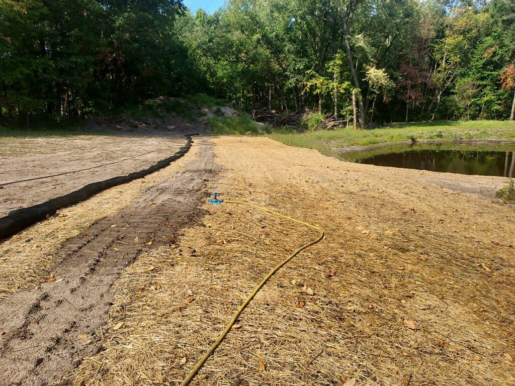 Completed straw mulch and silt sock erosion control installation in Northern Indiana