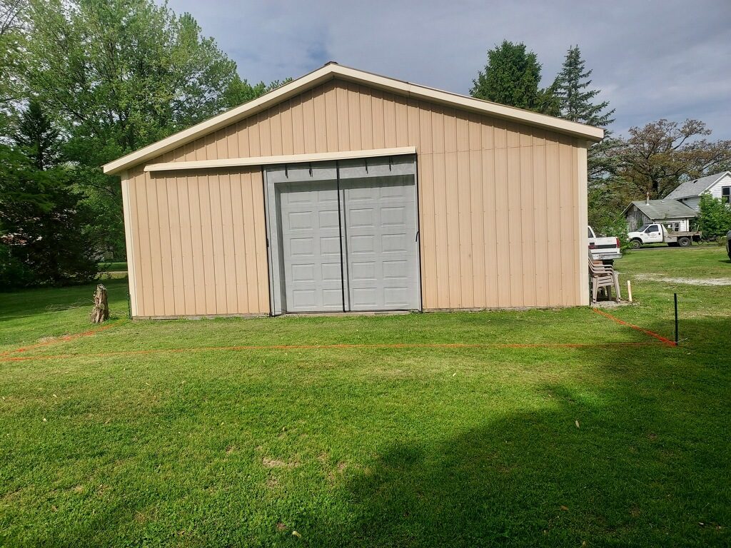 Marked layout for new gravel pad installation beside garage in Knox Indiana
