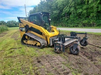 CAT skid loader with tiller attachment doing ground prep in Knox Indiana